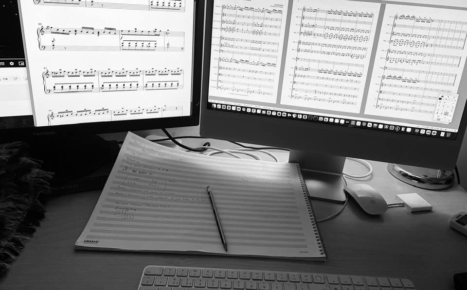 computer screens and music paper with notes